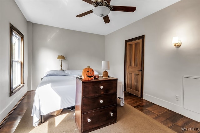 bedroom with ceiling fan and dark hardwood / wood-style flooring