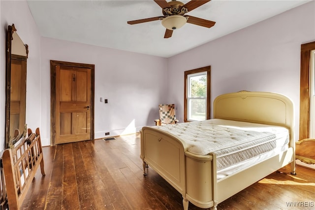 bedroom with dark wood-type flooring and ceiling fan