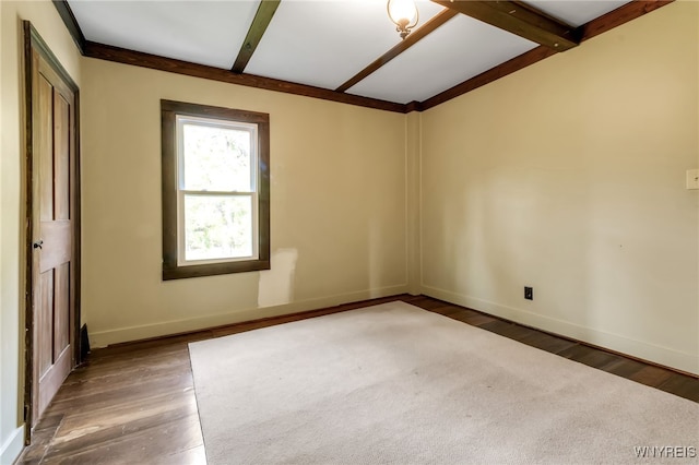 unfurnished room featuring beamed ceiling and wood-type flooring