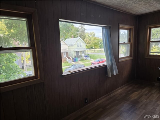 interior details featuring wood walls and wood-type flooring