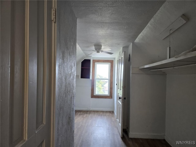 hall featuring hardwood / wood-style floors and vaulted ceiling