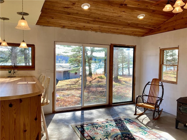 interior space with plenty of natural light, wood ceiling, concrete flooring, and vaulted ceiling