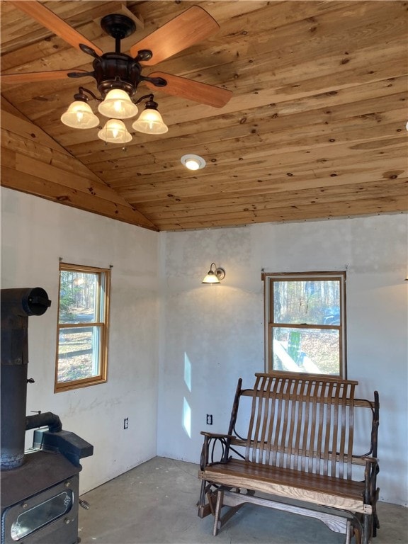 living area with concrete floors, vaulted ceiling, plenty of natural light, and wood ceiling