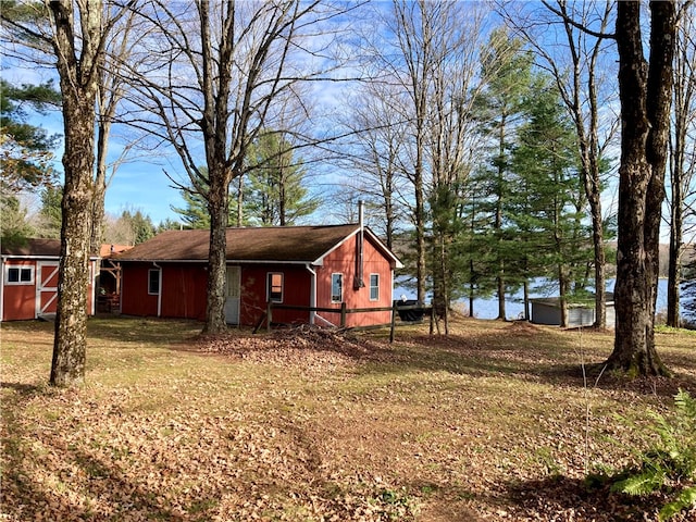 view of property exterior featuring a yard and a storage shed