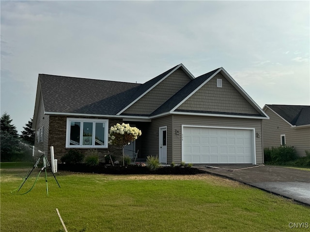 view of front facade with a front yard and a garage