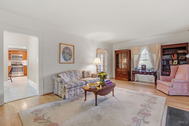 living room with crown molding and hardwood / wood-style floors