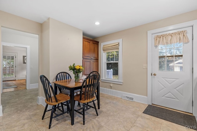 tiled dining room featuring plenty of natural light