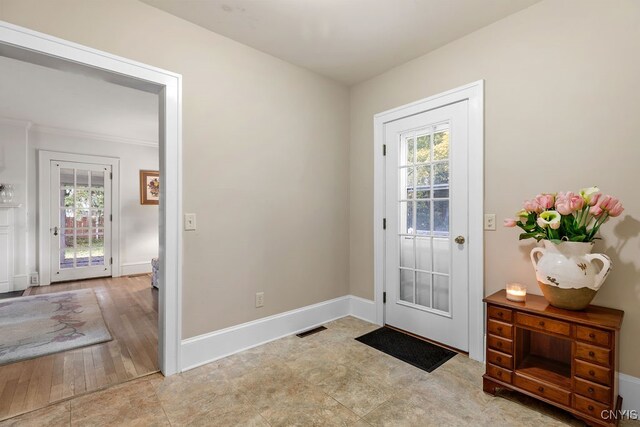 doorway to outside with light hardwood / wood-style floors and a healthy amount of sunlight