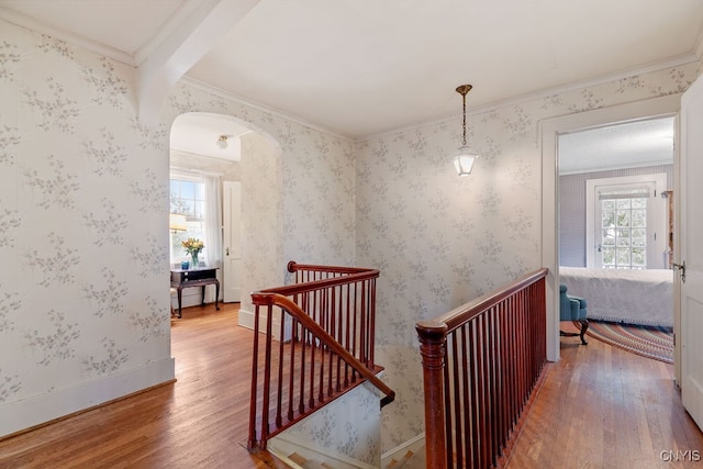 corridor featuring crown molding, hardwood / wood-style flooring, and beamed ceiling