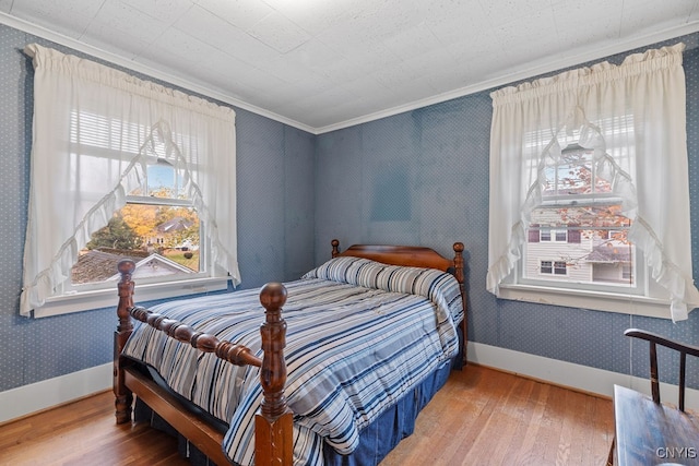 bedroom with crown molding and wood-type flooring