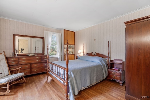 bedroom featuring crown molding and hardwood / wood-style flooring