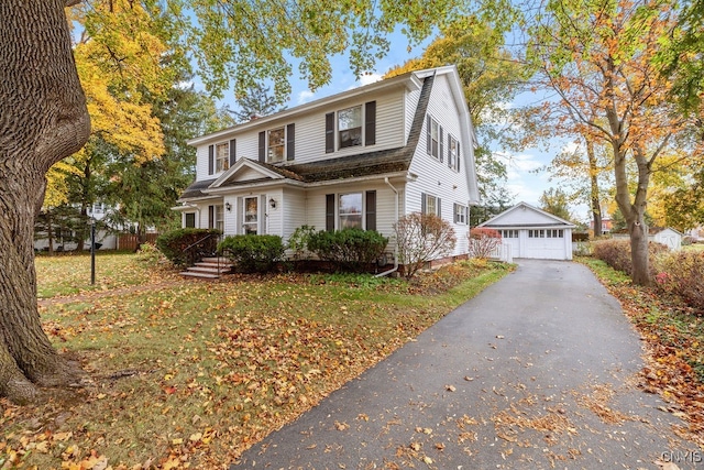 view of front property featuring an outdoor structure, a front yard, and a garage