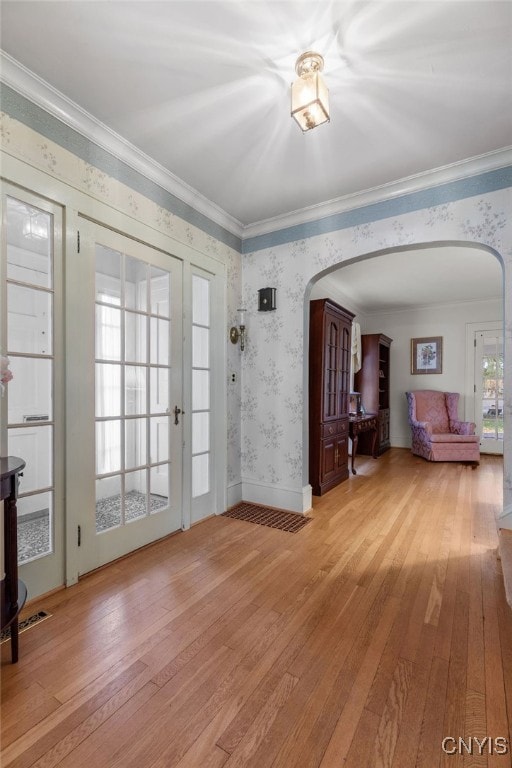 interior space featuring crown molding and light hardwood / wood-style floors