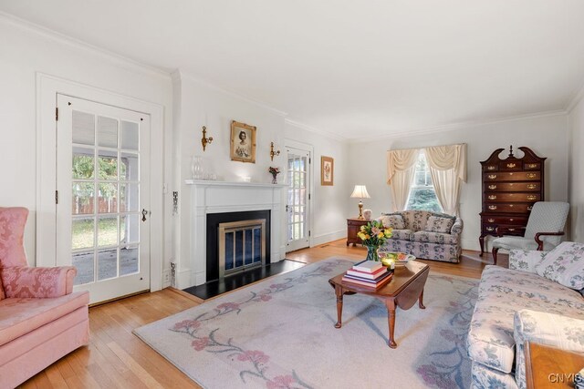 living room featuring light hardwood / wood-style floors and crown molding