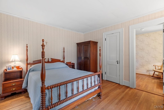 bedroom featuring crown molding and light wood-type flooring