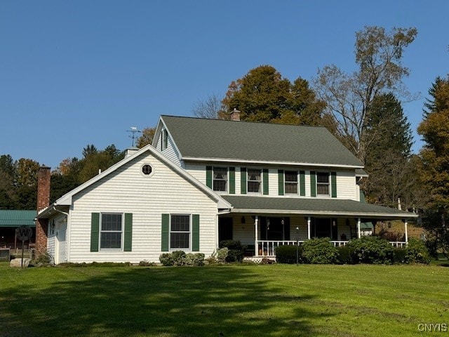 view of front facade with a front lawn and covered porch