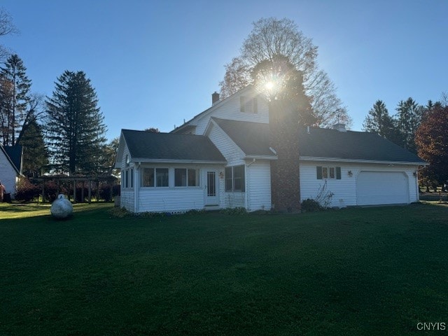 view of front of property with a front yard and a garage