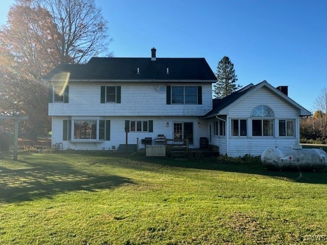 rear view of house with a lawn