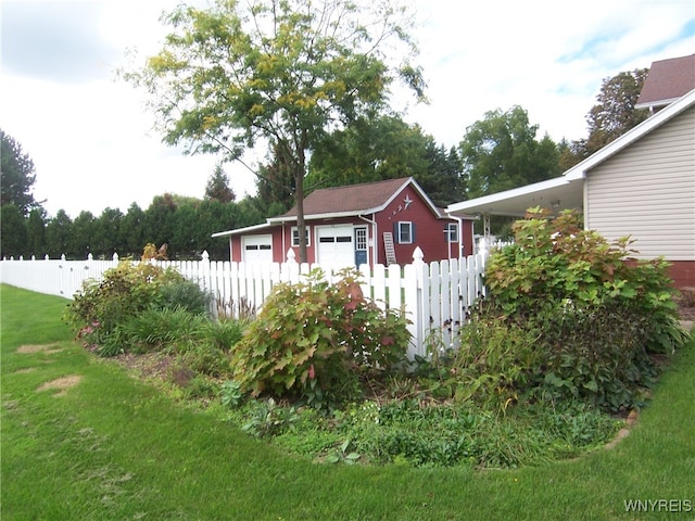 view of outbuilding with a yard and a garage