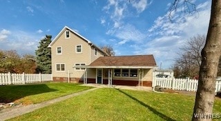 back of property featuring a yard