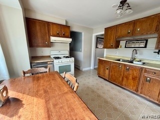 kitchen featuring white range with gas stovetop and sink