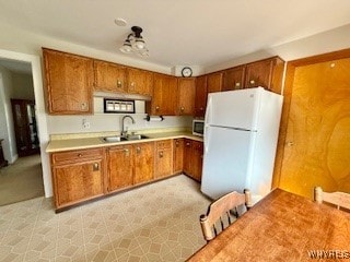 kitchen with sink and white refrigerator