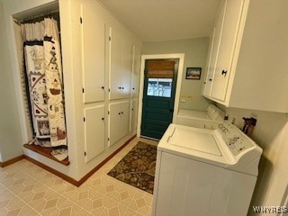 laundry area with cabinets, washing machine and dryer, and light tile patterned floors