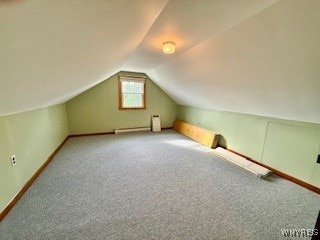 bonus room featuring vaulted ceiling and carpet flooring