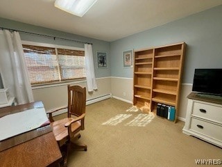 carpeted office space featuring a baseboard heating unit