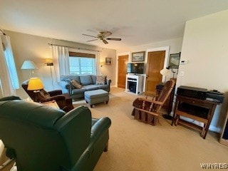 carpeted living room with ceiling fan