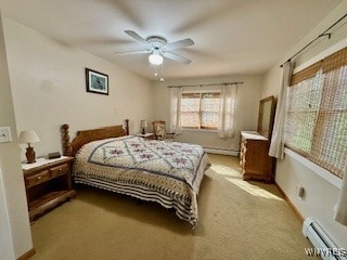 bedroom featuring light carpet, a baseboard heating unit, and ceiling fan