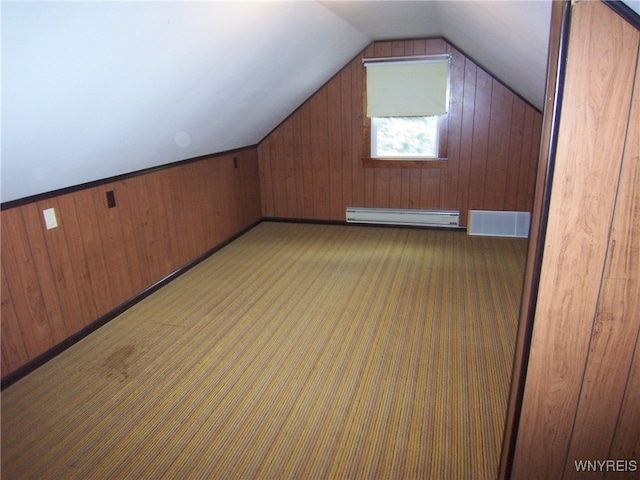 bonus room featuring a baseboard radiator, lofted ceiling, wooden walls, and dark colored carpet