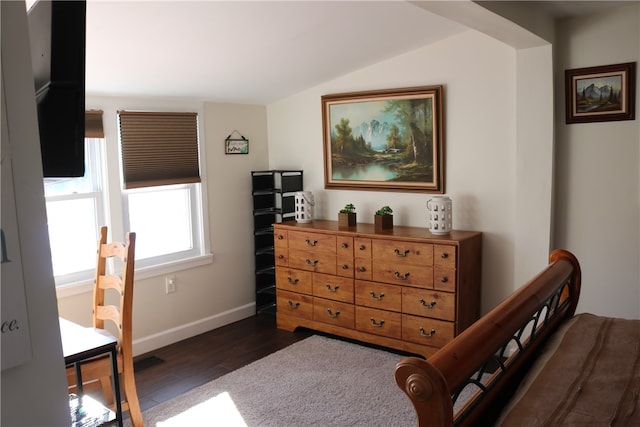 bedroom with lofted ceiling and dark hardwood / wood-style floors