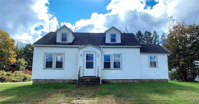 new england style home featuring a front yard