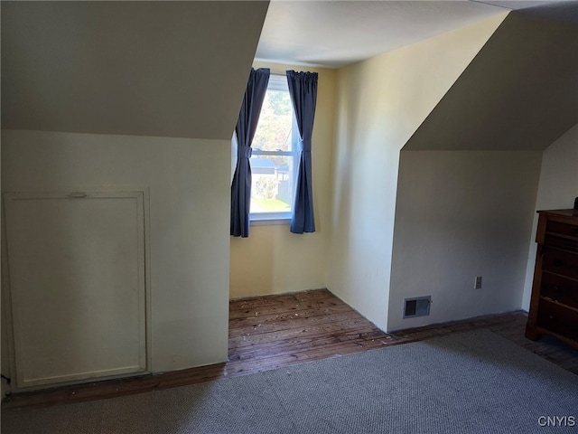 additional living space featuring lofted ceiling and hardwood / wood-style floors