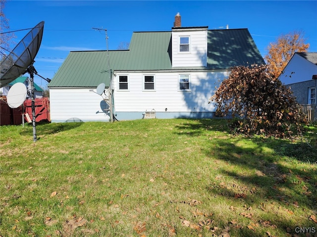 back of house featuring a lawn