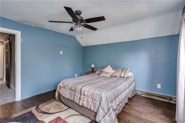 bedroom featuring a ceiling fan, a baseboard heating unit, wood finished floors, and vaulted ceiling