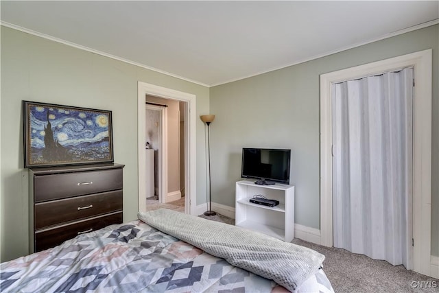 bedroom with carpet floors, ornamental molding, and baseboards
