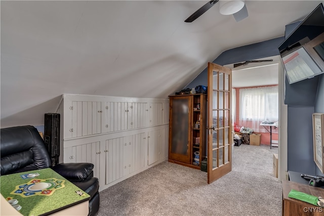 additional living space featuring vaulted ceiling, light carpet, and ceiling fan