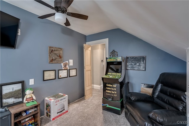 living area featuring light carpet, ceiling fan, and vaulted ceiling