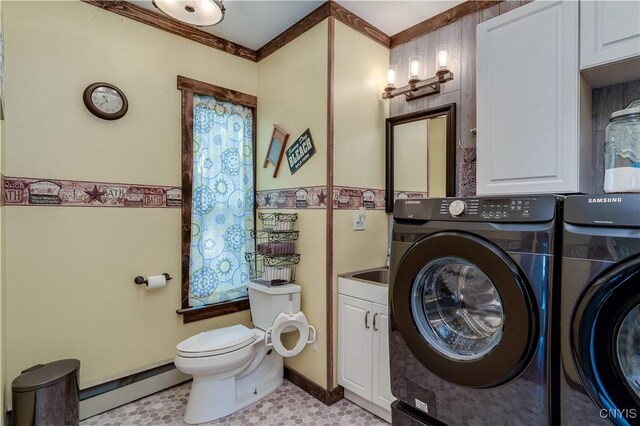 bathroom with baseboards, baseboard heating, toilet, and washer and clothes dryer