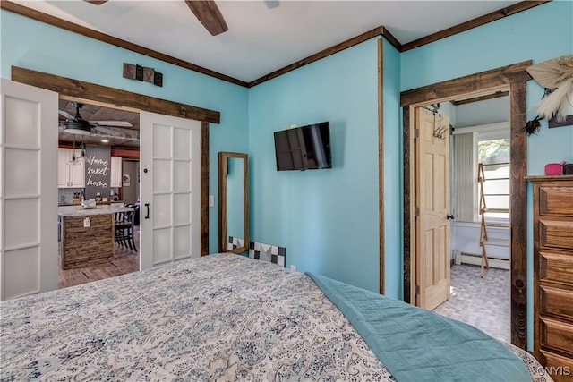 bedroom with a baseboard radiator, ornamental molding, and ceiling fan