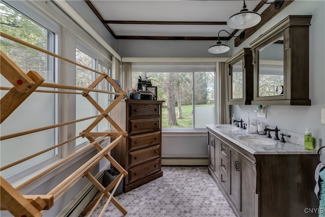 interior space featuring a wealth of natural light, a baseboard radiator, and vanity