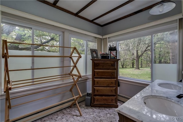 bathroom with a baseboard heating unit, a sink, and vaulted ceiling