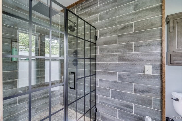 bathroom with tiled shower