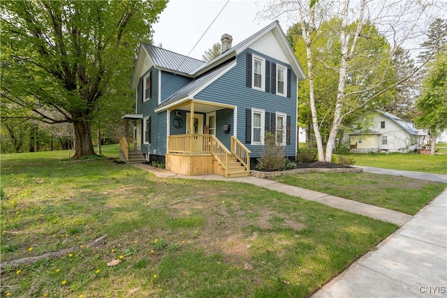 view of front facade with a front yard and covered porch