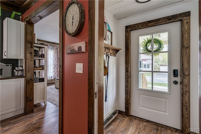 entryway with a baseboard heating unit and wood-type flooring