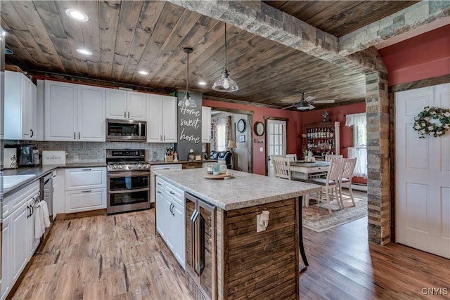 kitchen with wine cooler, wood ceiling, ceiling fan, and stainless steel appliances