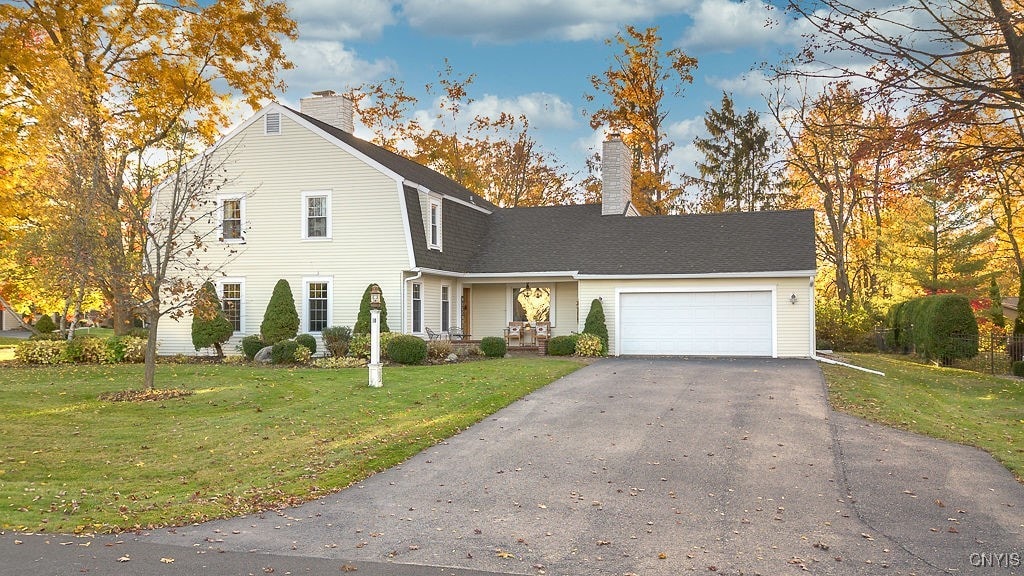 front of property featuring a garage and a front lawn