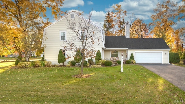 front facade featuring a front yard and a garage